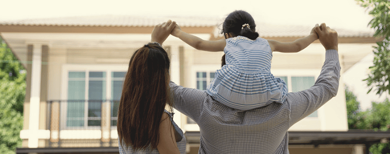 Happy family looking at an apartment building