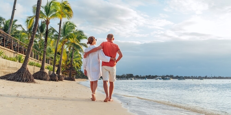 Couple in love hugging while walking on a sandy exotic beach. (1)
