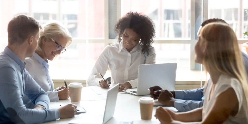 Signing contracts for services at group negotiations concept, diverse businesswomen seller and client company representatives partners making sale purchase business deal agreement at team meeting.jpg