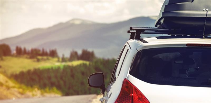A white SUV with a roof rack