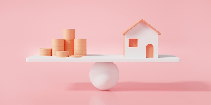 a house and a stack of loonies on a scale