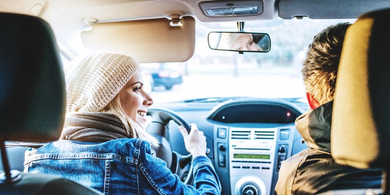 Couple driving in their car