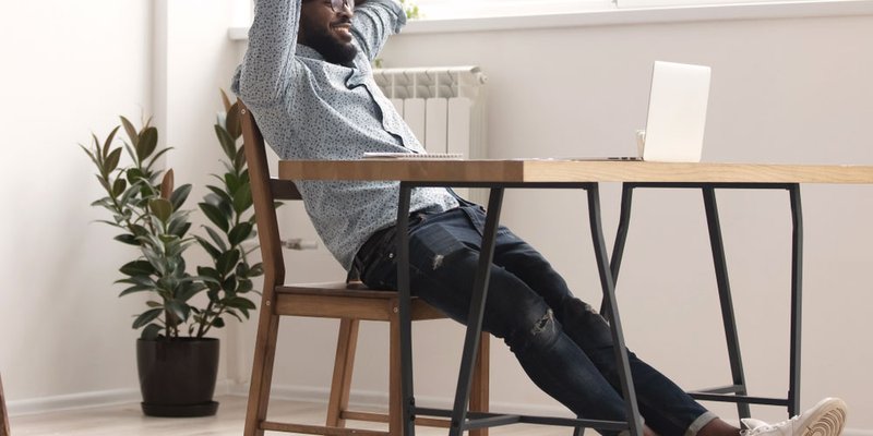 Man working on his laptop casually in modern coworking space