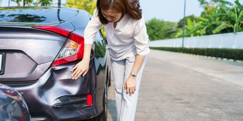 woman looking at a dented bumper_most common insurance claims.jpg
