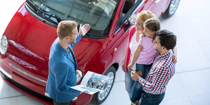 young family at dealership buying a new car.jpg